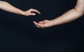 Female palm over male hand on black background Royalty Free Stock Photo