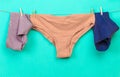 Female panties hanging on rope on pastel background - Image  - Image Royalty Free Stock Photo