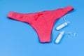 Female panty and tampons isolated on a blue background. Woman hygiene