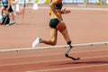 female para athlete on prosthetic leg running track stadium Royalty Free Stock Photo