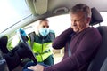 Female Paramedic Helping Mature Male Driver With Whiplash Injury Involved In Road Traffic Accident Royalty Free Stock Photo