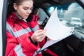 female paramedic sitting in ambulance and looking Royalty Free Stock Photo