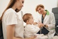 Female parent with infant at eye doctor appointment