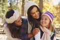 Female parents and daughter in a forest looking at each other Royalty Free Stock Photo