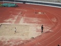 Female parents play with their young children in the sand pit of the sports center