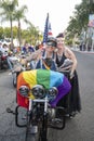 Female participants pose by motorcycles during WeHo Pride festival