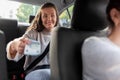 female passenger giving money to taxi car driver Royalty Free Stock Photo