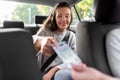 female passenger giving money to taxi car driver Royalty Free Stock Photo