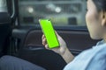 Female passenger using a phone with blank screen