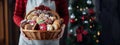 A female pastry chef holds a basket with various Christmas cookies. Banner, place for text