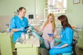 Female patien with two doctors at the dental office