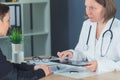 Female patient consulted by doctor in hospital office