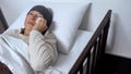 Female patient crying in hospital bed, wiping tears with handkerchief, cancer Royalty Free Stock Photo