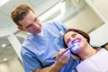 Female patient at dentis teeth whitening procedure Royalty Free Stock Photo