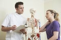 Female Patient Describing Neck Injury To Osteopath Royalty Free Stock Photo