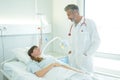 Female patient and doctor have consultation in hospital room Royalty Free Stock Photo