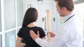 Female patient examining spine at physiotherapist at vertebrology center.