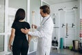 Female patient examining spine at physiotherapist at vertebrology center