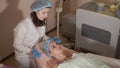 Female patient getting facial mask in spa beauty salon