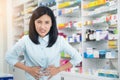 Female patient having stomach pain background pharmacy. Healthcare and medical concept