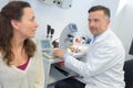 Female patient interacting with optometrist in ophthalmology clinic Royalty Free Stock Photo