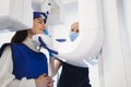 Female patient make a dental computer tomograph. The radiologist makes a CT scan of the jaw. Royalty Free Stock Photo