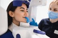 Female patient make a dental computer tomograph. The radiologist makes a CT scan of the jaw Royalty Free Stock Photo