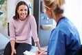 Female Patient And Nurse Have Consultation In Hospital Room Royalty Free Stock Photo