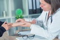 Female patient at orthopedic doctor medical exam for wrist injur Royalty Free Stock Photo