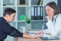 Female patient at orthopedic doctor medical exam for wrist injury