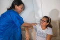 Female Patient in the physiotherapy doing physical exercises with her therapist, he gives her a medical massage Royalty Free Stock Photo