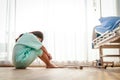 Female patient sitting on the floor stressed with sick disease