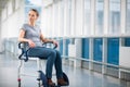 Female patient, sitting in a wheelchair for patients