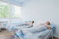 Female patient sleeping in medical bed at the hospital ward Royalty Free Stock Photo