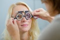 female patient under going eye test through phoropter Royalty Free Stock Photo