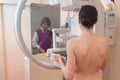 Female patient undergoing mammogram in clinic