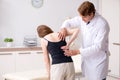 The female patient visiting young handsome doctor chiropractor