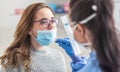 Female patient wearing mask over mouth is having sample taken from nose for a pcr test for Covid 19 Royalty Free Stock Photo
