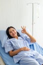 Female patients lie in bed Hold your finger ok