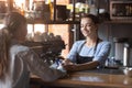 Female pay bill holding credit card using NFC modern technology Royalty Free Stock Photo