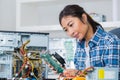 Female pc technician posing next to disassembled desktop Royalty Free Stock Photo