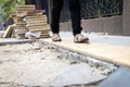 Female pedestrians people is walking on a footpath walkway under construction and stacked cobblestone block or renovation,damaged Royalty Free Stock Photo