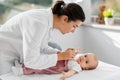 Female pediatrician doctor with baby at clinic