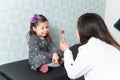 Smiling Girl Looking At Doctor Holding Candy In Clinic Royalty Free Stock Photo