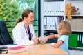 Female pediatrician has candys for a little girl