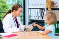 Female pediatrician has candys for a little girl