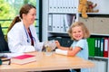 Female pediatrician has candys for a little girl