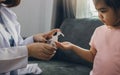 Female pediatrician is holding a bottle of alcohol hand sanitizer gel to wash hands kill germs and bacteria for children during