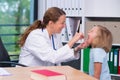 Female pediatrician in white lab coat examined little patient Royalty Free Stock Photo