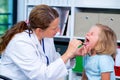 Female pediatrician in white lab coat examined little patient Royalty Free Stock Photo